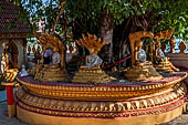 Vientiane, Laos - Pha That Luang, among the other structures on the ground there is a circular platform surrounding a large Bodhi tree contains Buddha images in several mudras.  